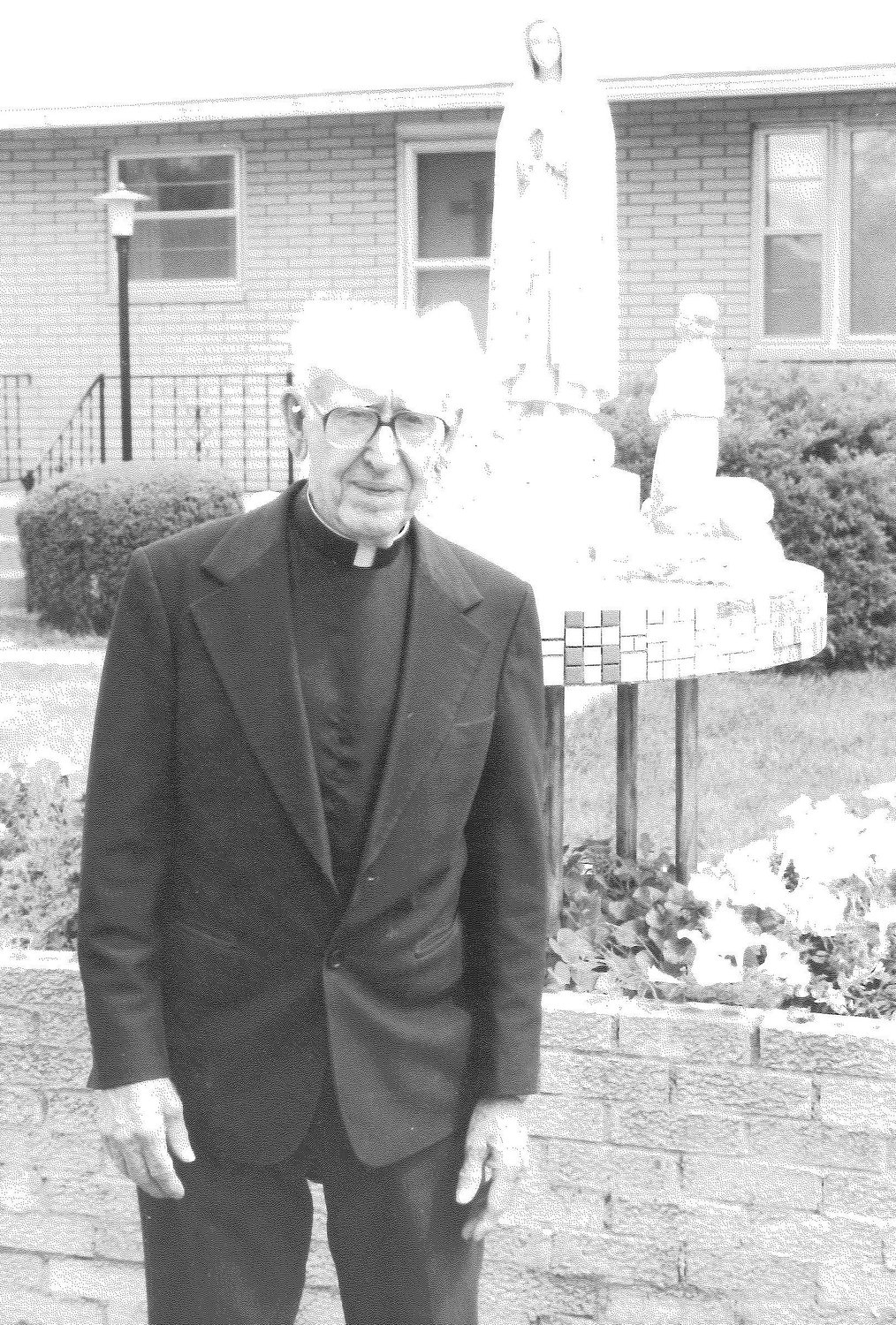 Monsignor Joseph Mahoney, now deceased, stands outside the St. Patrick Rectory in Clarence in this 1985 file photo. The rectory is being converted to transitional housing for mothers and children in need, with help from a Charity and Mercy Grant from Catholic Charities of Central and Northern Missouri.